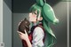 A girl with green hair holding a brown rabbit.